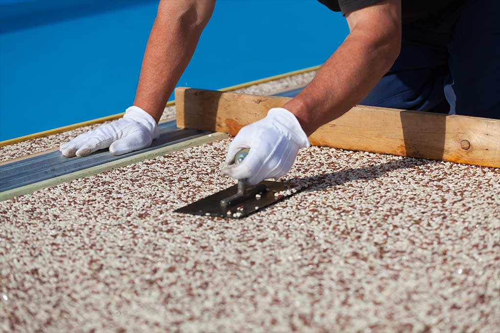 Bricklayer worker installing epoxy flooring