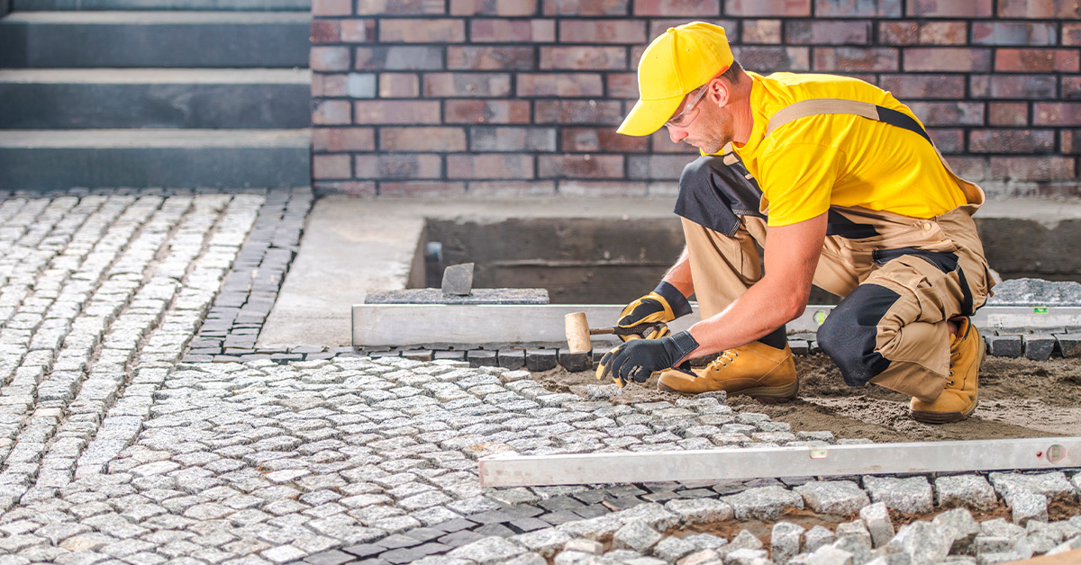 careers at Pacheco Custom Masonry - custom masonry patios contractor working on a beautiful patio with intricate stone detailing